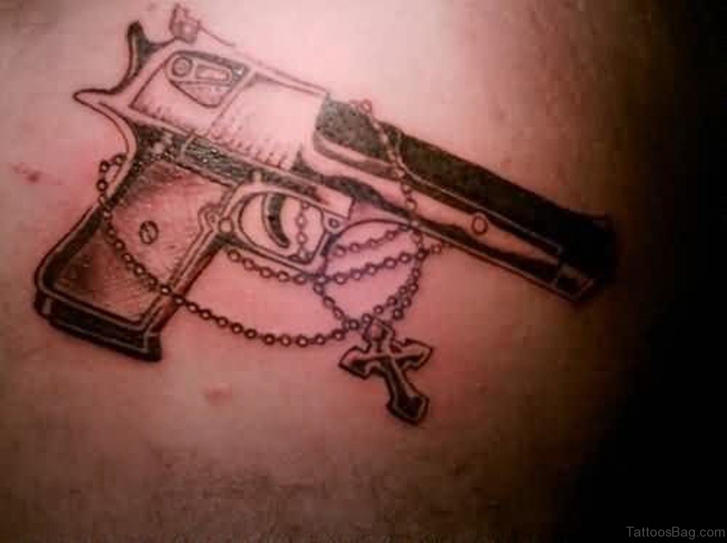 Gun with Cross Tattoo On Back.