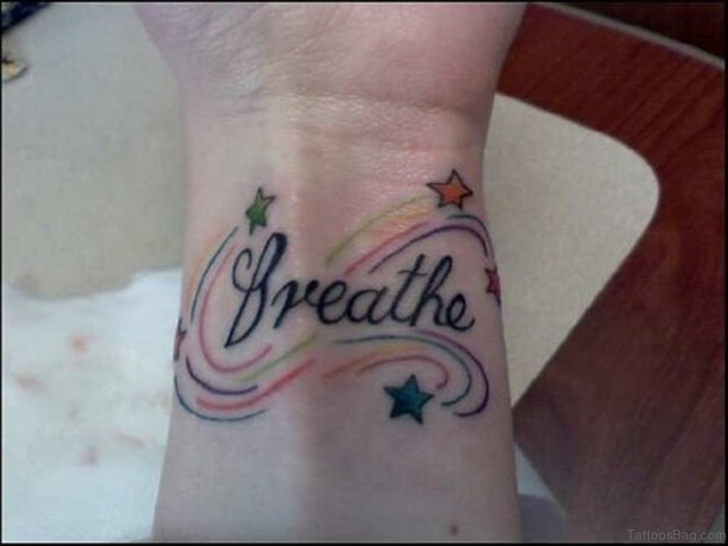 Stars And Just Breathe Tattoo On Wrist.