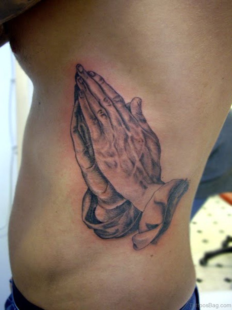 Praying hands tattoo rib cage
