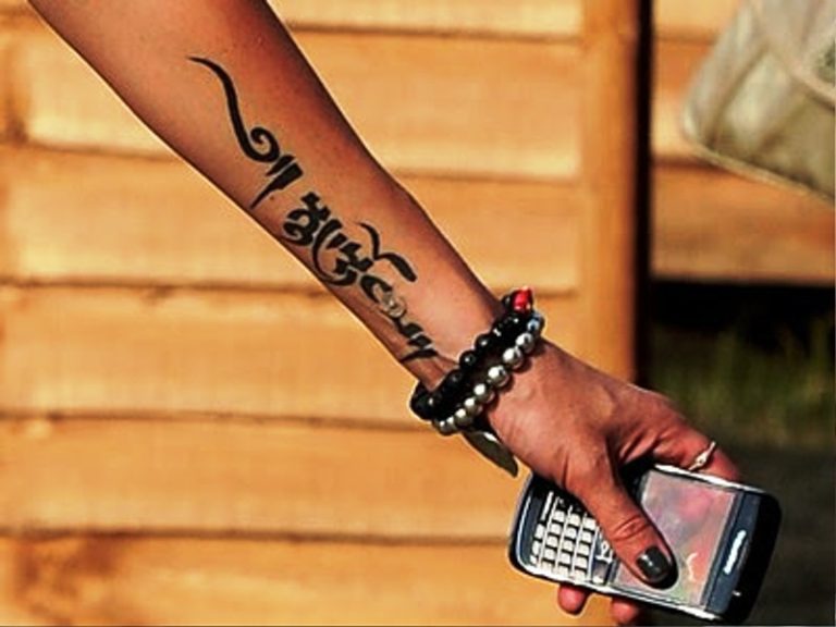 Black Arabic Tattoo On Arm.