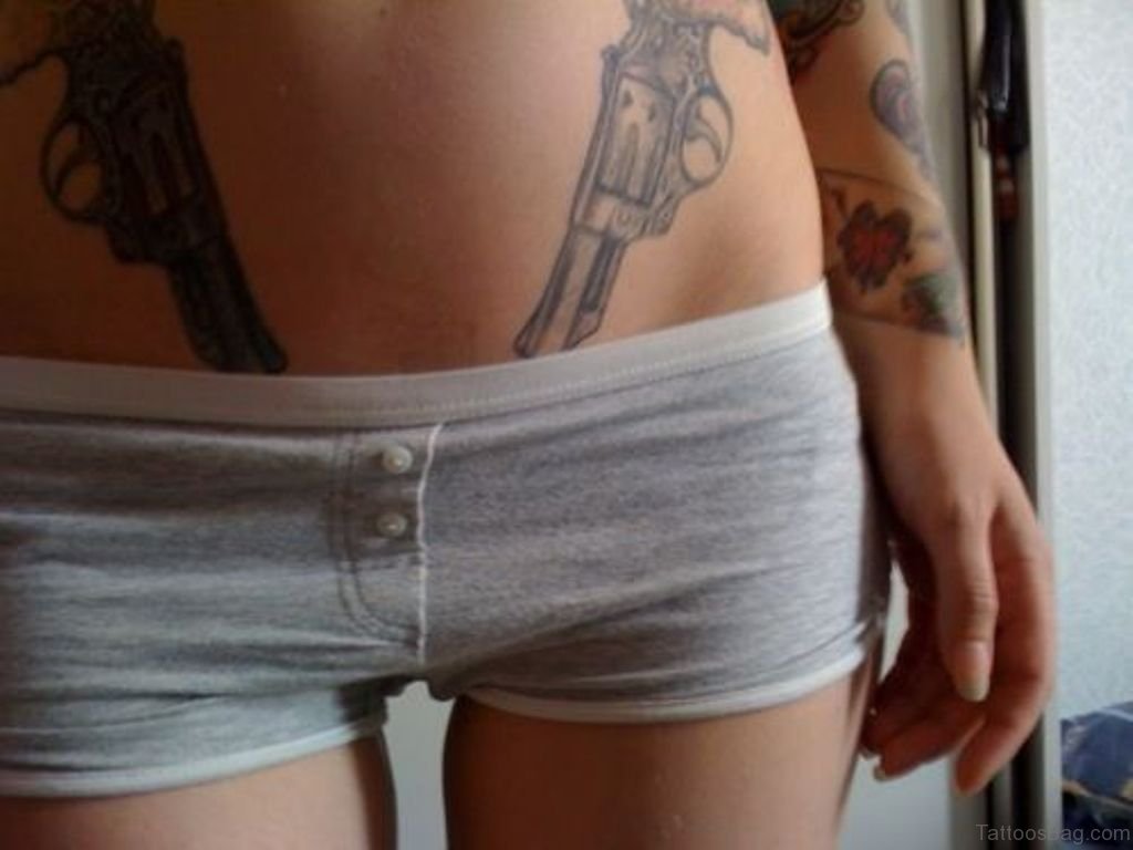 Grey Ink Gun Tattoo.